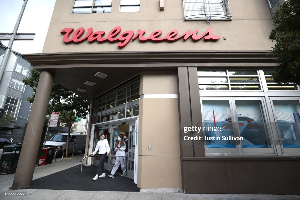 Customers leave a Walgreens store that is set to be closed in the