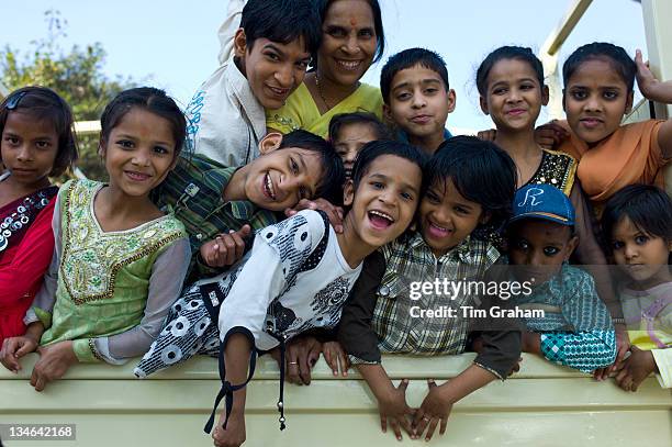 Indian children in back of TATA truck at Mehrauli, New Delhi, India