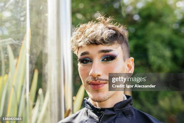 portrait of a non-binary graduate - eyelash extensions stock pictures, royalty-free photos & images