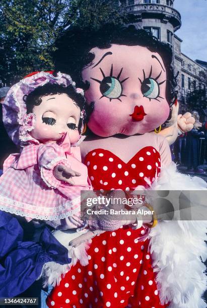 Portrait of a Macy's Thanksgiving Day Parade participant dressed as 'Betty Boop' and holding a baby version of the same character, New York, New...