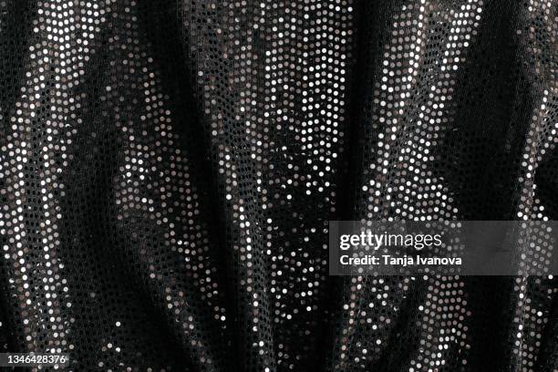 black textile fabric with shiny sequins as background. - lap dancing stockfoto's en -beelden