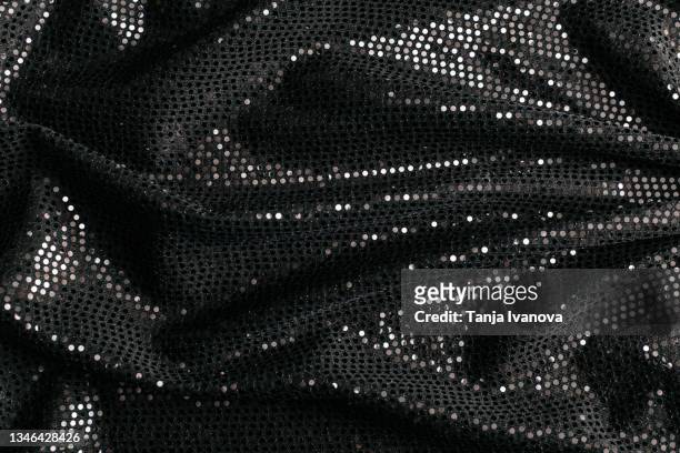 black textile fabric with shiny sequins as background. - fashion show stock-fotos und bilder