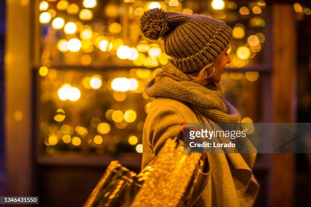 a beautiful blonde women at winter shopping - amsterdam christmas stock pictures, royalty-free photos & images