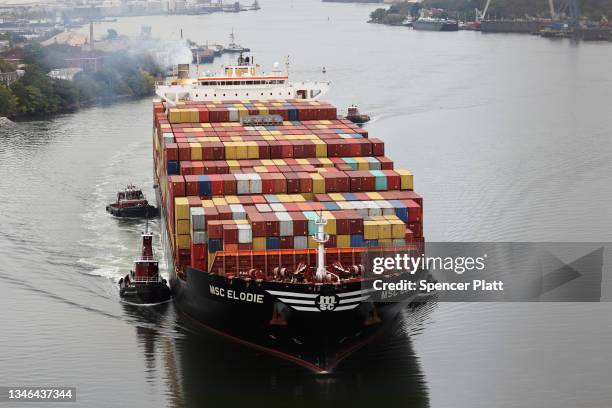 Cargo ship moves under the Bayonne Bridge as it heads into port on October 13, 2021 in Bayonne, New Jersey. As surging inflation and supply chain...