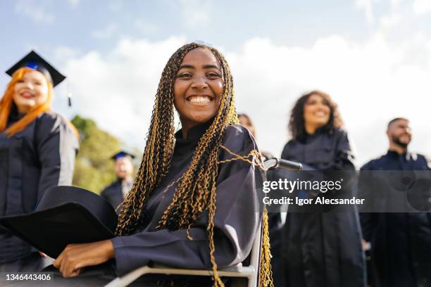graduate in wheelchair - graduates stockfoto's en -beelden