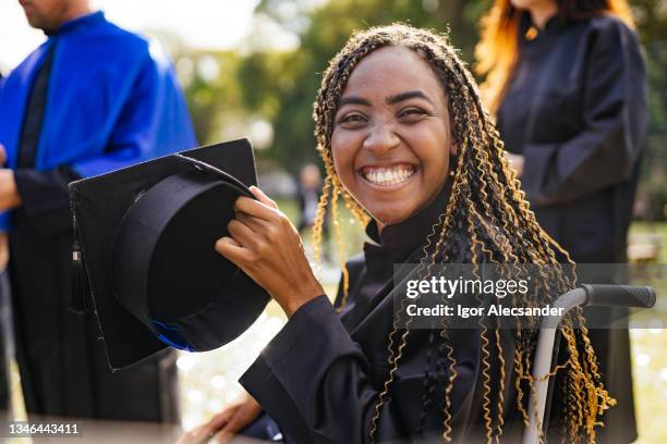 student in wheelchair at graduation - black woman graduation stock pictures, royalty-free photos & images