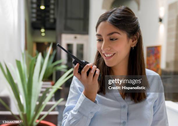 hotel receptionist talking on a walkie-talkie - walkie talkie stock pictures, royalty-free photos & images