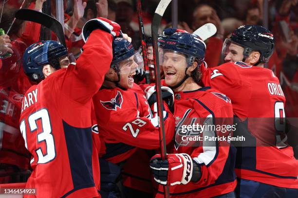 Hendrix Lapierre of the Washington Capitals celebrates his first career NHL goal with teammates against the New York Rangers during the second period...