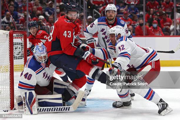 Tom Wilson of the Washington Capitals is checked by Patrik Nemeth of the New York Rangers during the second period at Capital One Arena on October...