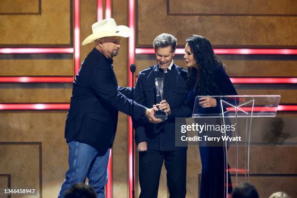 Garth Brooks awards Randy Travis their Artists of a Lifetime award onstage with Mary Travis during 2021 CMT Artist Of The Year at Schermerhorn...