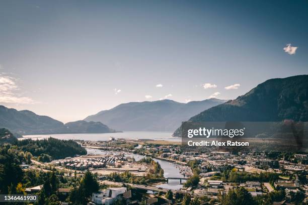 aerial view of squamish, british columbia on sunny day - squamish stock pictures, royalty-free photos & images