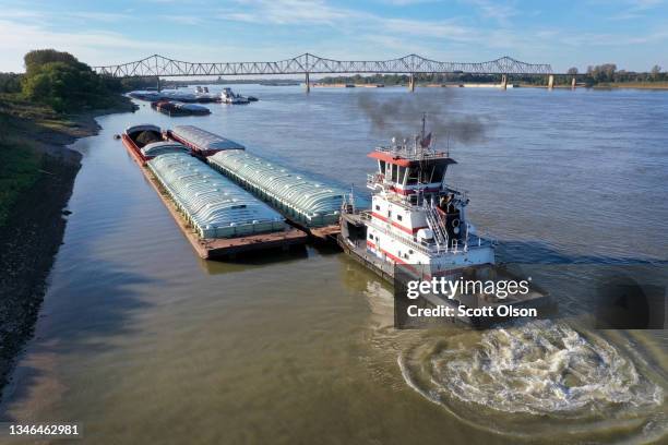 Tug pushes barges on the Ohio River on October 12, 2021 near Cairo, Illinois. According to U.S. Census data, Alexander County Illinois, of which...