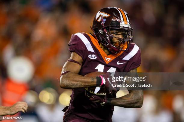 Tre Turner of the Virginia Tech Hokies carries the ball against the Notre Dame Fighting Irish during the first half of the game at Lane Stadium on...