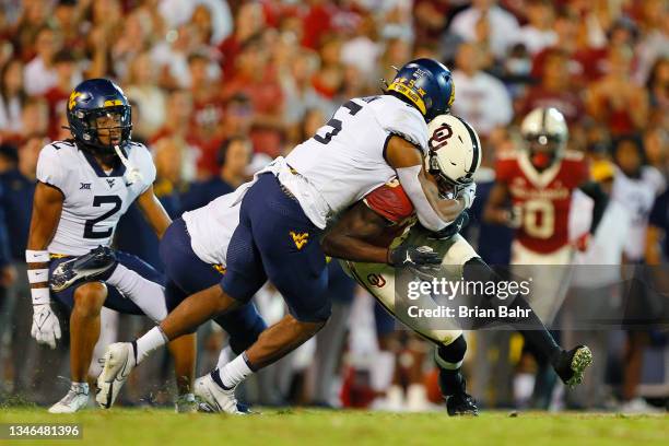 Linebacker Lance Dixon of the West Virginia Mountaineers stops wide receiver Michael Woods II of the Oklahoma Sooners with a 12-yard catch on...