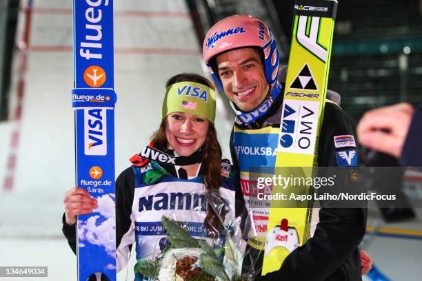 The winners, Sarah Hendrickson of USA and Andreas Kofler of Austria pose after the competition of the Ski Jumping HS100 during day one of the FIS...