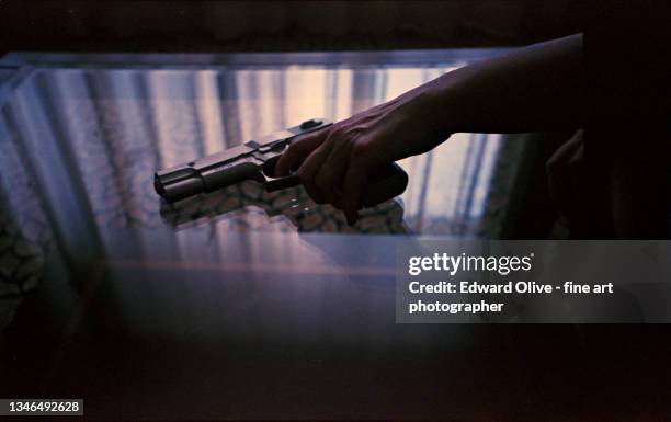 spy thriller book cover design with man holding pistol gun. - mob stockfoto's en -beelden