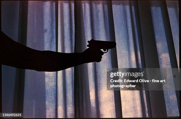 spy thriller book cover design with man holding pistol gun. - crime fotografías e imágenes de stock