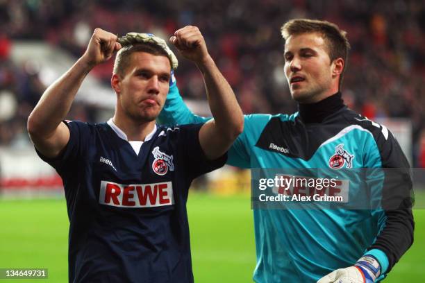 Lukas Podolski and goalkeeper Michael Rensing of Koeln celebrate with supporters after the Bundesliga match between VfB Stuttgart and 1. FC Koeln at...