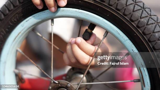 little boy repairing a bicycle - resourceful bildbanksfoton och bilder