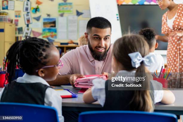 helping to make learning fun - male teacher stock pictures, royalty-free photos & images