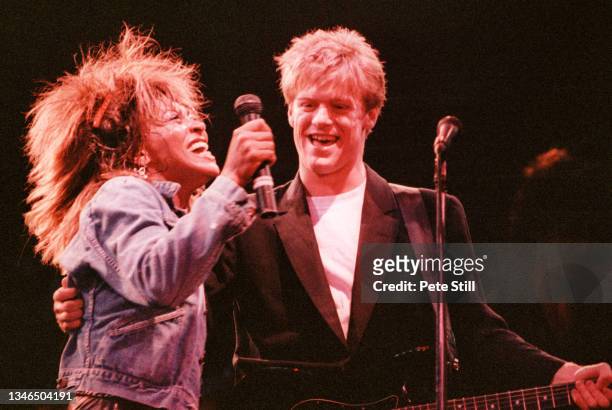 Tina Turner performs on stage with Bryan Adams at Wembley Arena during her 'Private Dancer' tour, on March 14th, 1985 in London, England.