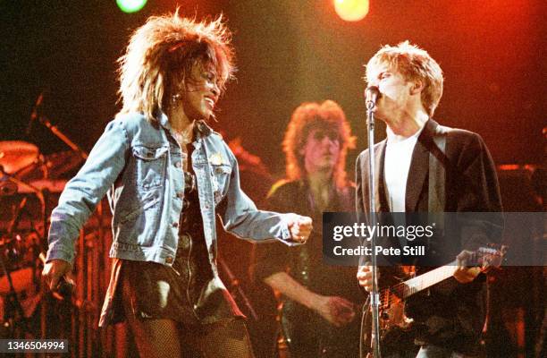 Tina Turner performs on stage with Bryan Adams at Wembley Arena during her 'Private Dancer' tour, on March 14th, 1985 in London, England.