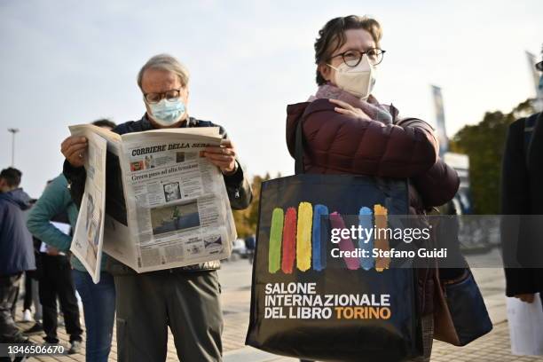 Woman holds a bag with a Turin International Book Fair logo on it during the Inauguration of Turin International Book Fair on October 14, 2021 in...