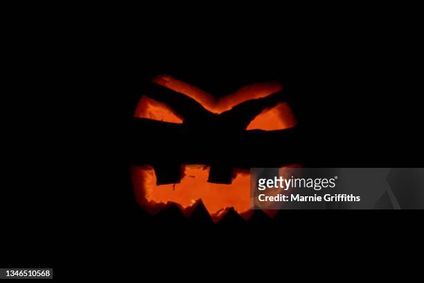 halloween pumpkin illuminated - halloween lantern stock pictures, royalty-free photos & images
