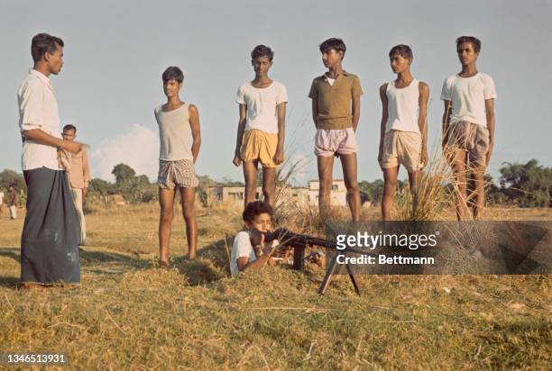 Soldiers of the Mukti Bahini during rifle range training session, one operates a rifle mounted on a bipod, 20 miles from the border with India, in...