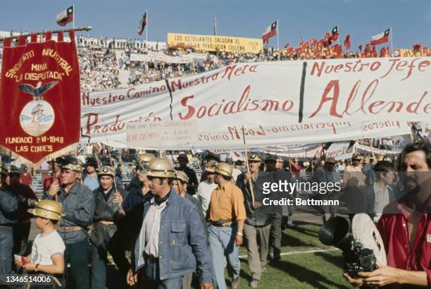 Various groups of miners, with signs congratulating the 'people's government', taking part in the festivities marking the first anniversary of...