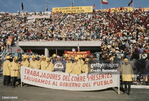 Various groups of miners, with signs congratulating the 'people's government', taking part in the festivities marking the first anniversary of...