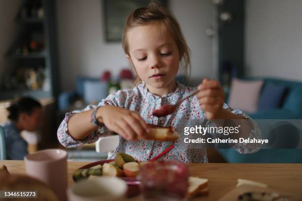 a little girl having her breakfast - crostini imagens e fotografias de stock
