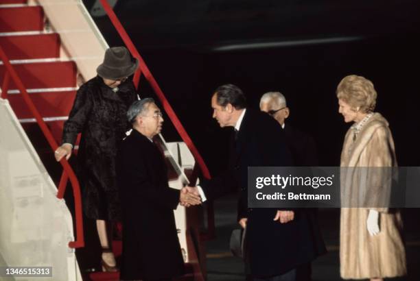 Empress Kojun and Hirohito are greeted by American politician Richard Nixon and First Lady Pat Nixon shake hands after Hirohito and his wife had...