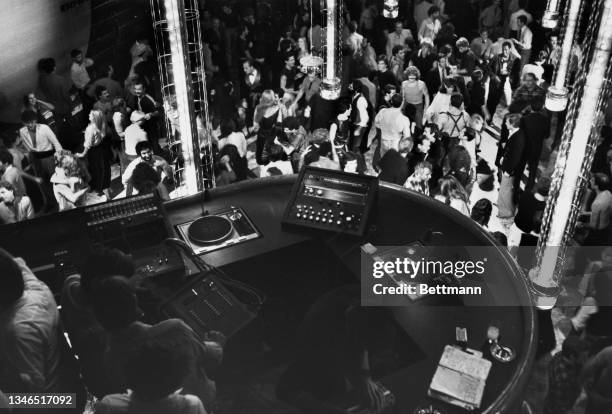 High angle view looking down over the turntables and mixer in the DJ booth which overlooks the dancers on the dancefloor below at the reopened Studio...