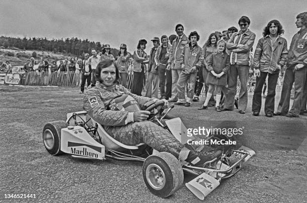 Brazilian racing driver Emerson Fittipaldi in a miniature race car, UK, June 1974.