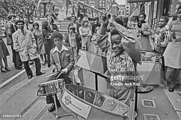 Members of the Oxford Road Primary School Steel Band from Reading perform outside the Royal Court Theatre in London, where the play 'Play Mas' is...