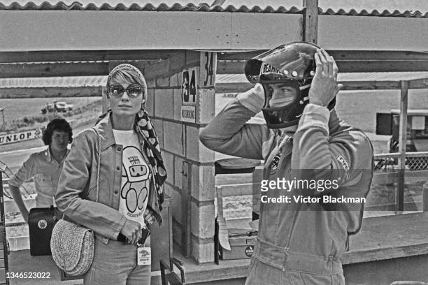 British racing driver James Hunt with his fiancée, model Suzy Miller in the run-up to the British Grand Prix, UK, 17th July 1974. Miller is wearing a...