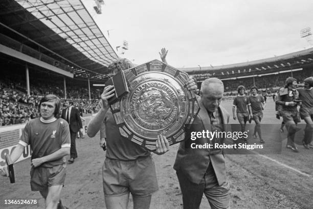 Bill Shankly , manager of Liverpool FC, accompanies his team around the pitch after winning the Football Association Charity Shield on penalties in a...