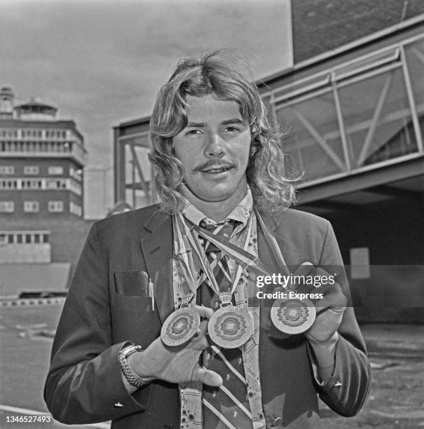 Scottish swimmer David Wilkie at Heathrow Airport in London with the three medals he won at the 13th European Aquatics Championships in Vienna,...