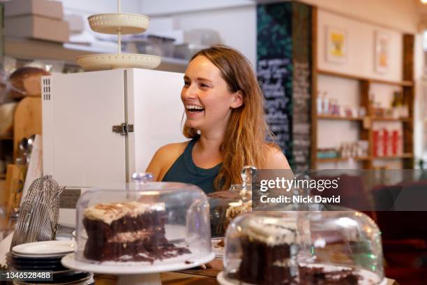 a cheerful waitress working in a busy cafe - femalefocuscollection stock pictures, royalty-free photos & images