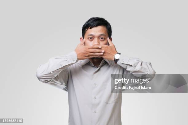 speak no evil - man finger on lips stock pictures, royalty-free photos & images