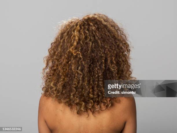 rear view of mid adult woman with blonde curly hair - curly hair back stock pictures, royalty-free photos & images