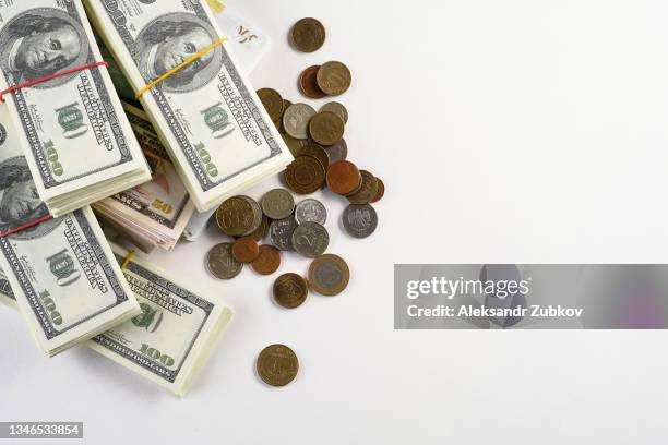 us dollars and euros, eu and us banknotes in bundles on a white background. coins from different countries. the concept of finance and economics. salary, bribe, profit or credit funds. copy space. - fajo de billetes de euro fotografías e imágenes de stock