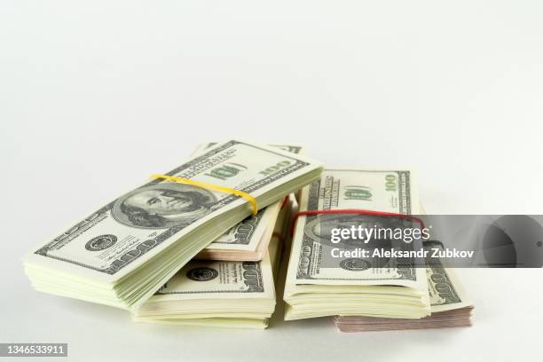 us dollars us banknotes in bundles on a white background. the concept of finance and economics. salary, bribe, profit or credit funds. copy space. - bundle stock pictures, royalty-free photos & images