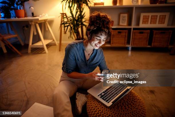 young businesswoman working from home at night - opening night of the boy from oz arrivals and after party stockfoto's en -beelden