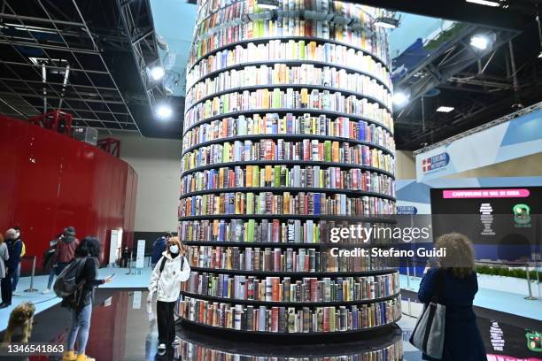 People stand near of column of books during of the Turin International Book Fair on October 14, 2021 in Turin, Italy. The Turin International Book...