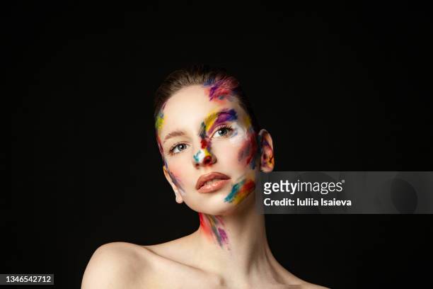 woman with painted face on black background in studio - art modeling studio stock pictures, royalty-free photos & images