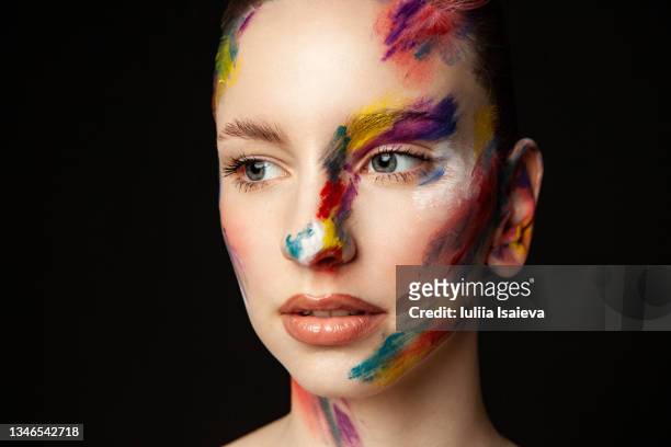 woman with painted face on black background in studio - art modeling studio stock pictures, royalty-free photos & images
