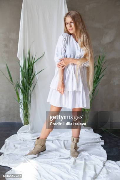 woman in white dress in studio with green plants - woman full body isolated stock pictures, royalty-free photos & images