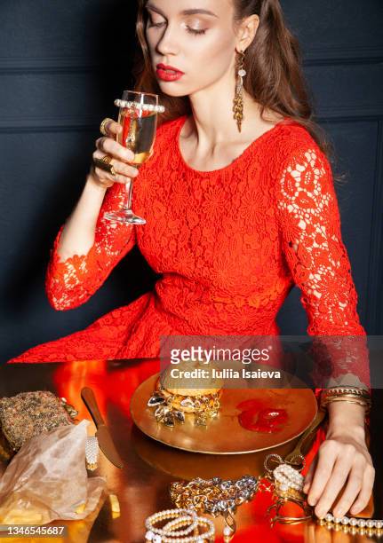 rich woman drinking champagne and eating fast food - costume jewellery stock pictures, royalty-free photos & images
